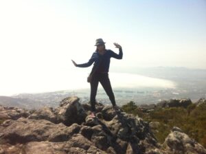 Picture of EnlightenHarmony admin on top of a mountain in Cape Town